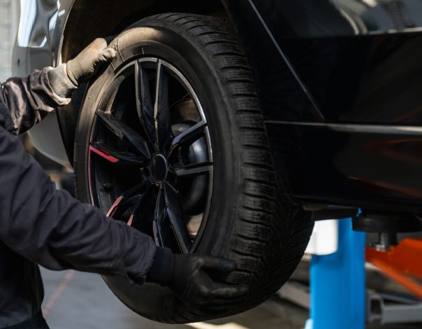 Man replacing a tire on a car